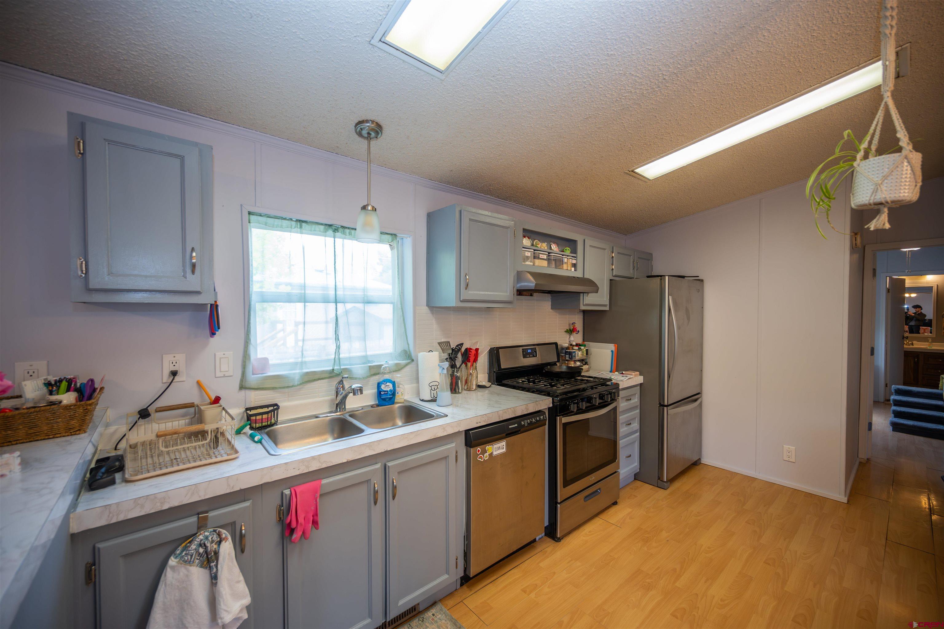 2 Mulberry Way Durango, CO 81301 - Photo 9 of 40 a kitchen with a sink stove and refrigerator