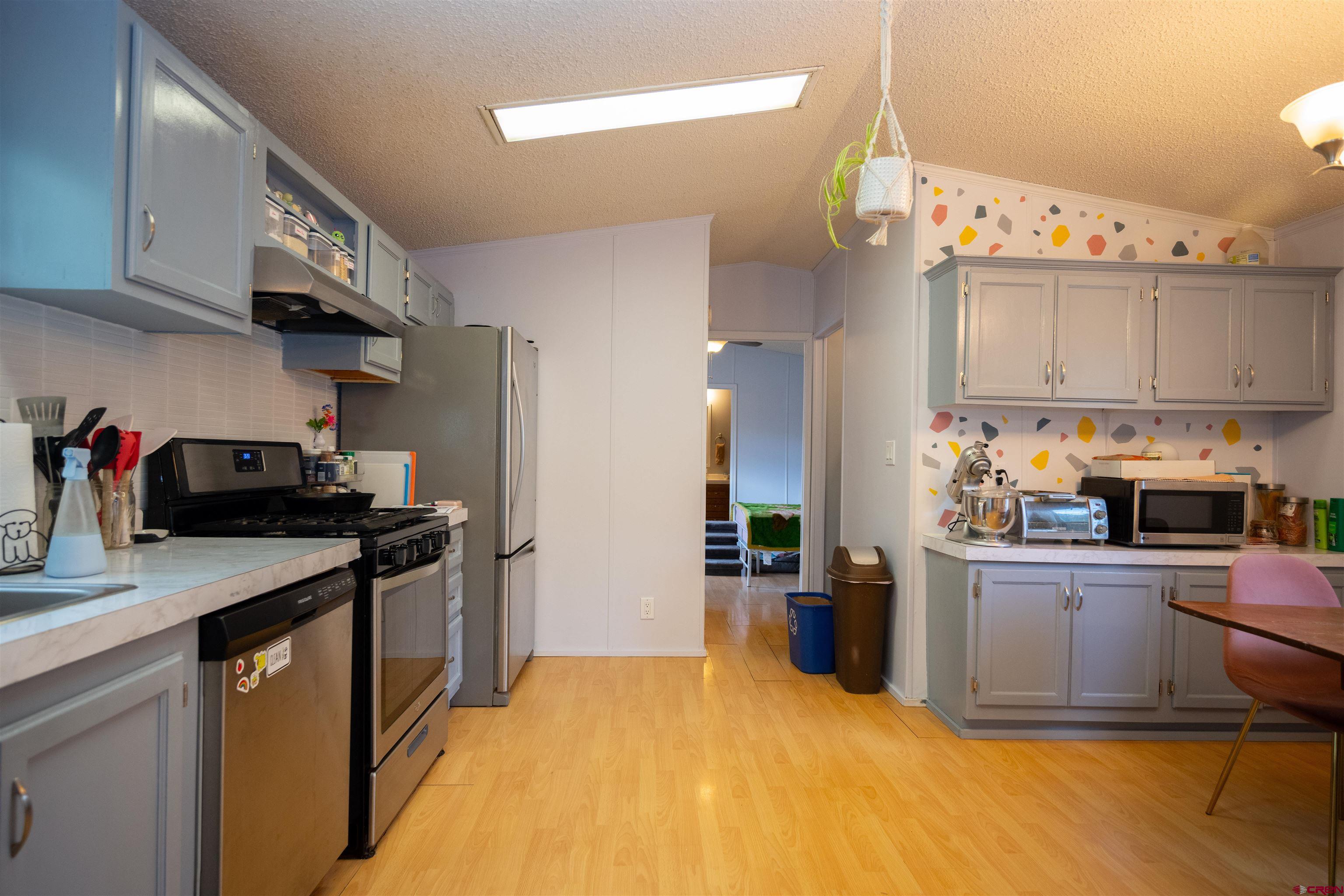 2 Mulberry Way Durango, CO 81301 - Photo 10 of 40 a kitchen with a sink a stove and refrigerator
