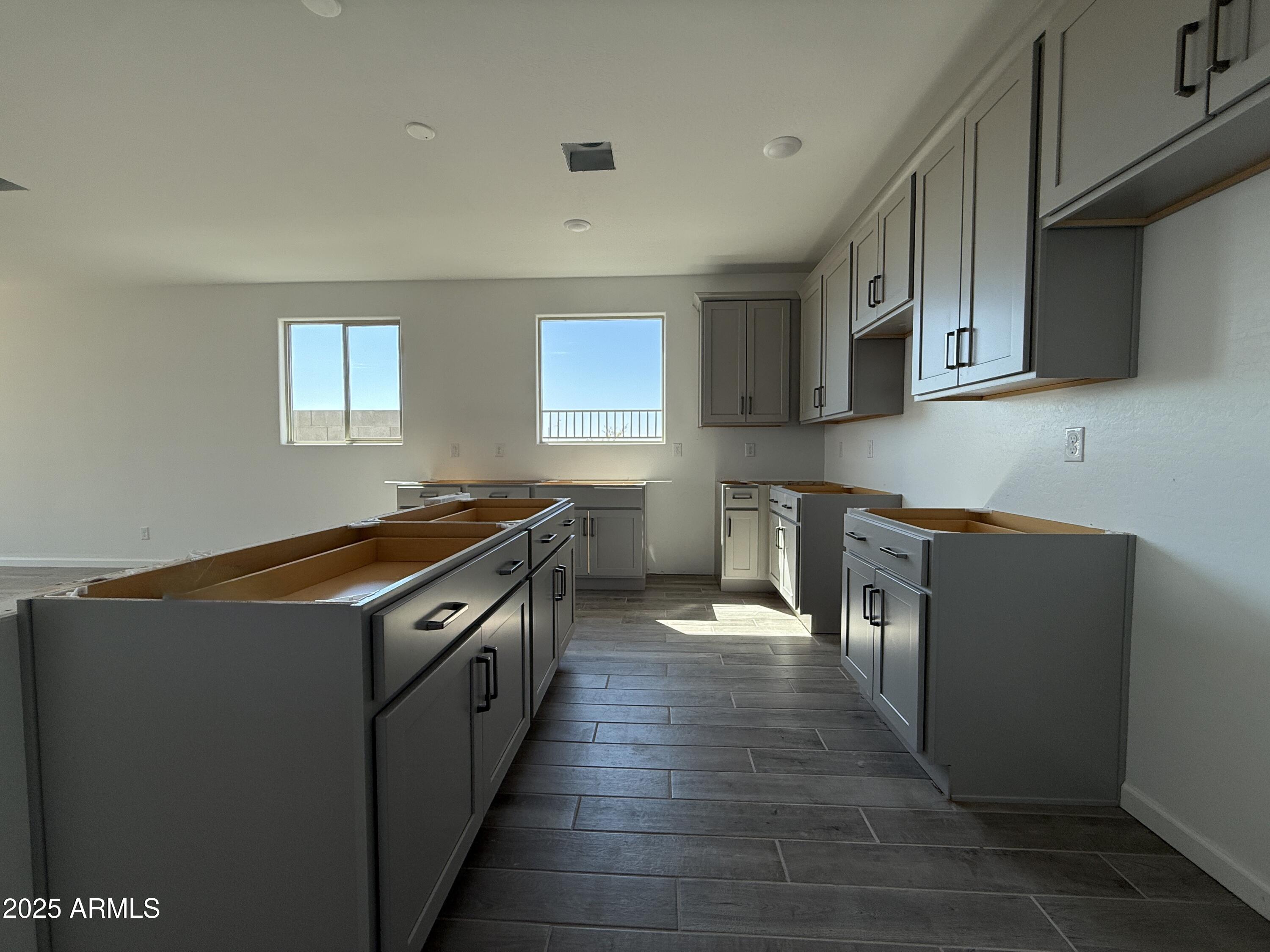 9627 West Tamarisk Avenue Tolleson, AZ 85353 - Photo 11 of 42 a kitchen with stainless steel appliances granite countertop a stove and a sink