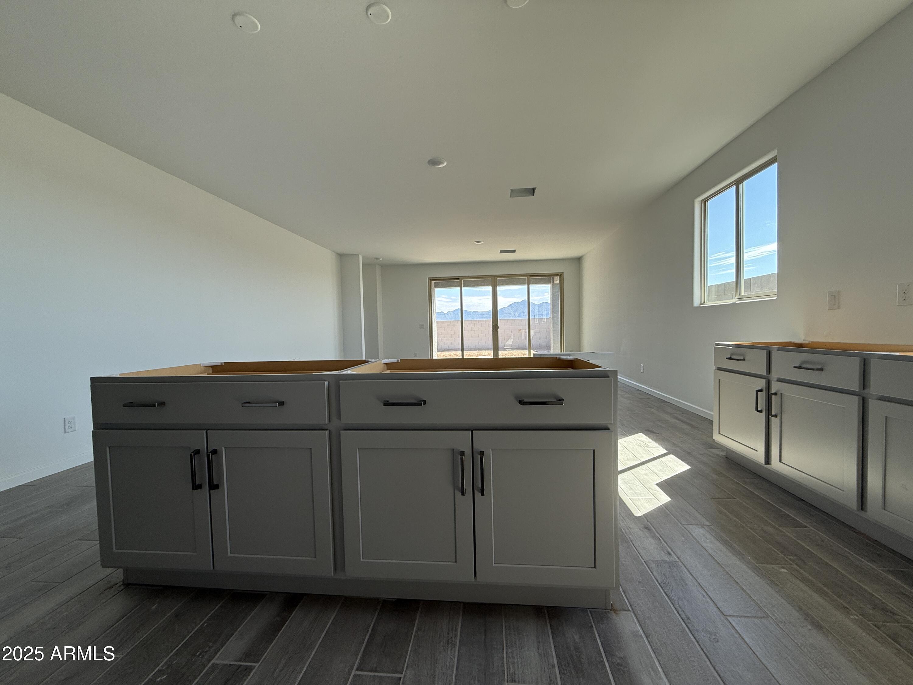 9627 West Tamarisk Avenue Tolleson, AZ 85353 - Photo 14 of 42 a living room with hard wood floors and a sink