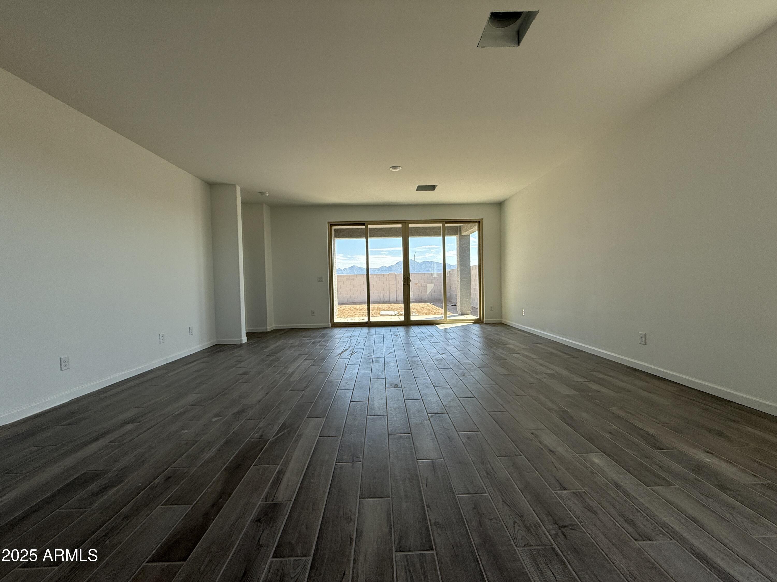 9627 West Tamarisk Avenue Tolleson, AZ 85353 - Photo 17 of 42 wooden floor in an empty room with a window