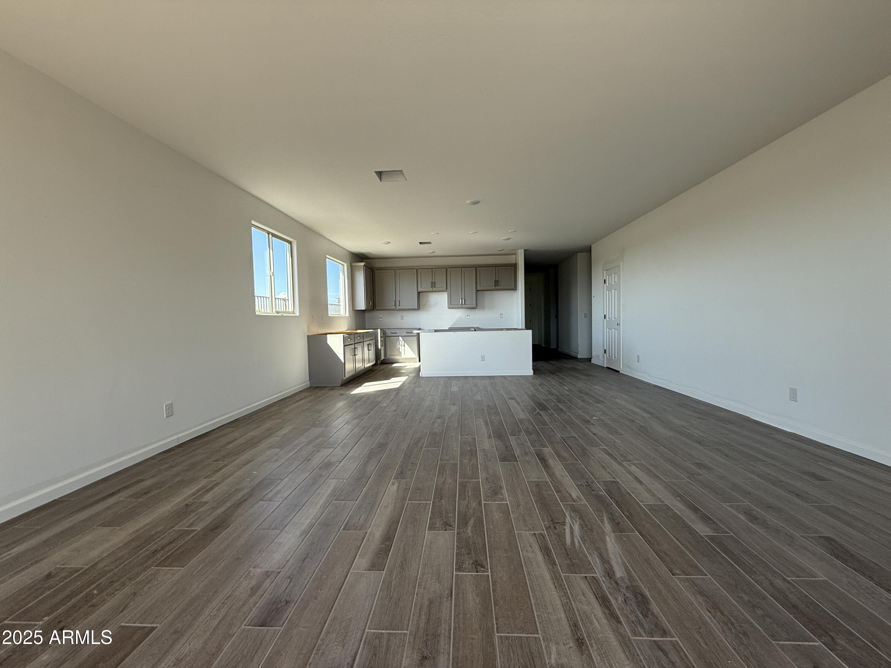 9627 West Tamarisk Avenue Tolleson, AZ 85353 - Photo 18 of 42 a view of empty room with wooden floor
