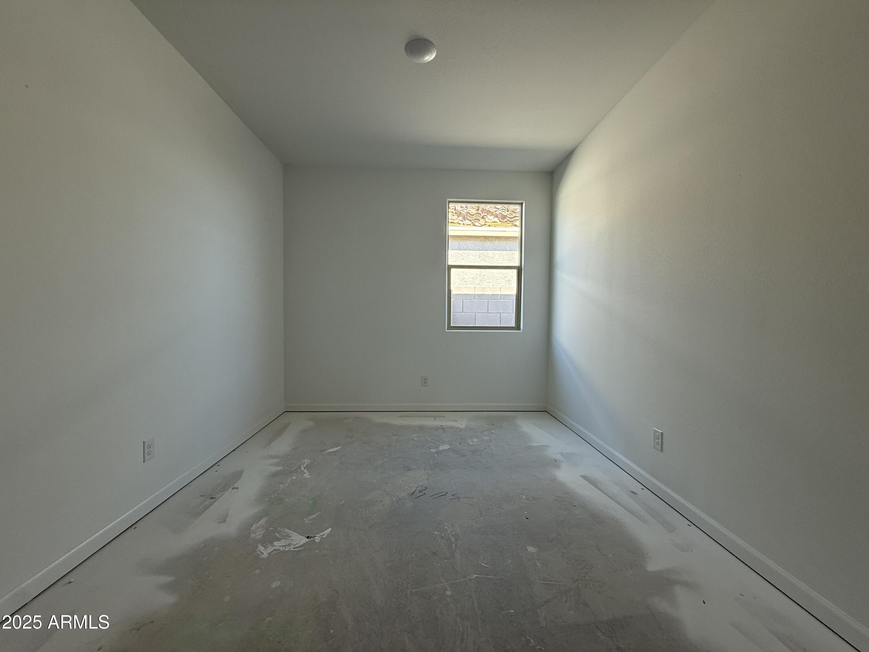 9627 West Tamarisk Avenue Tolleson, AZ 85353 - Photo 22 of 42 an empty room with windows