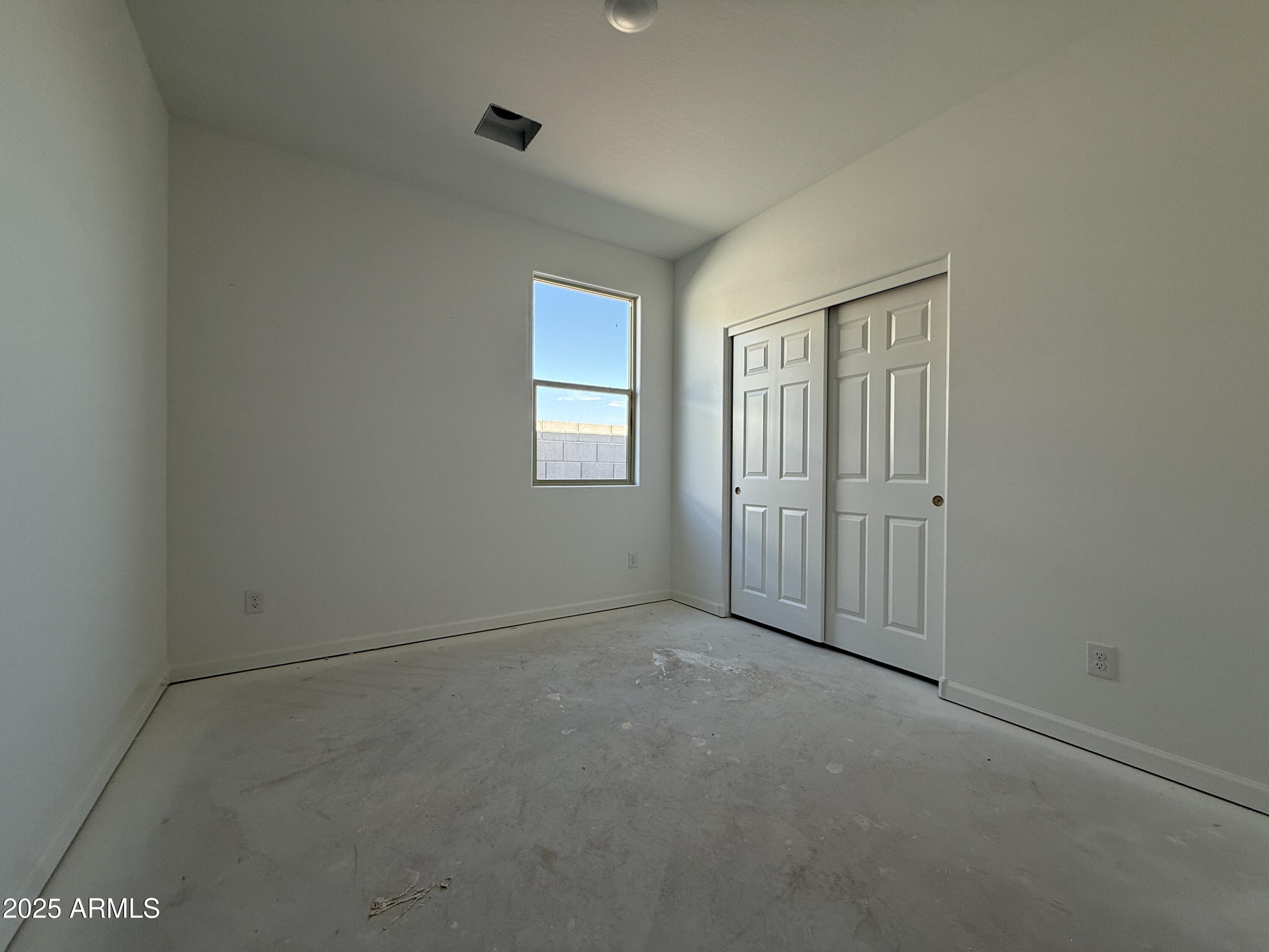 9627 West Tamarisk Avenue Tolleson, AZ 85353 - Photo 23 of 42 an empty room with windows