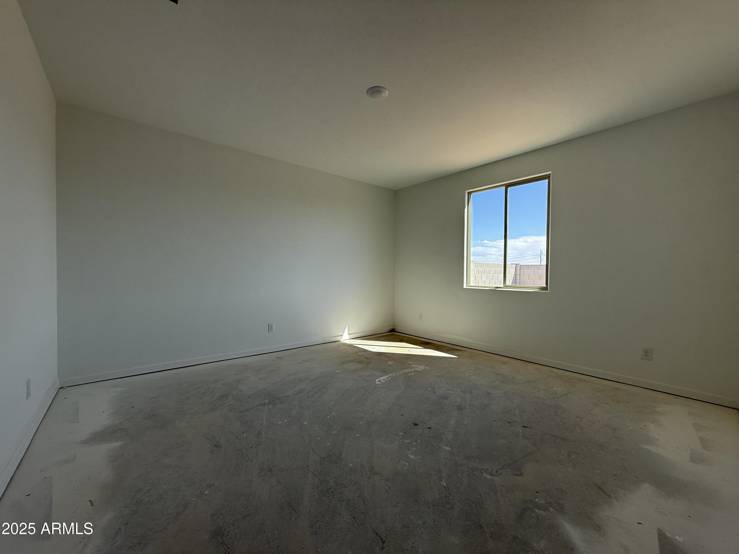 9627 West Tamarisk Avenue Tolleson, AZ 85353 - Photo 26 of 42 an empty room with a window