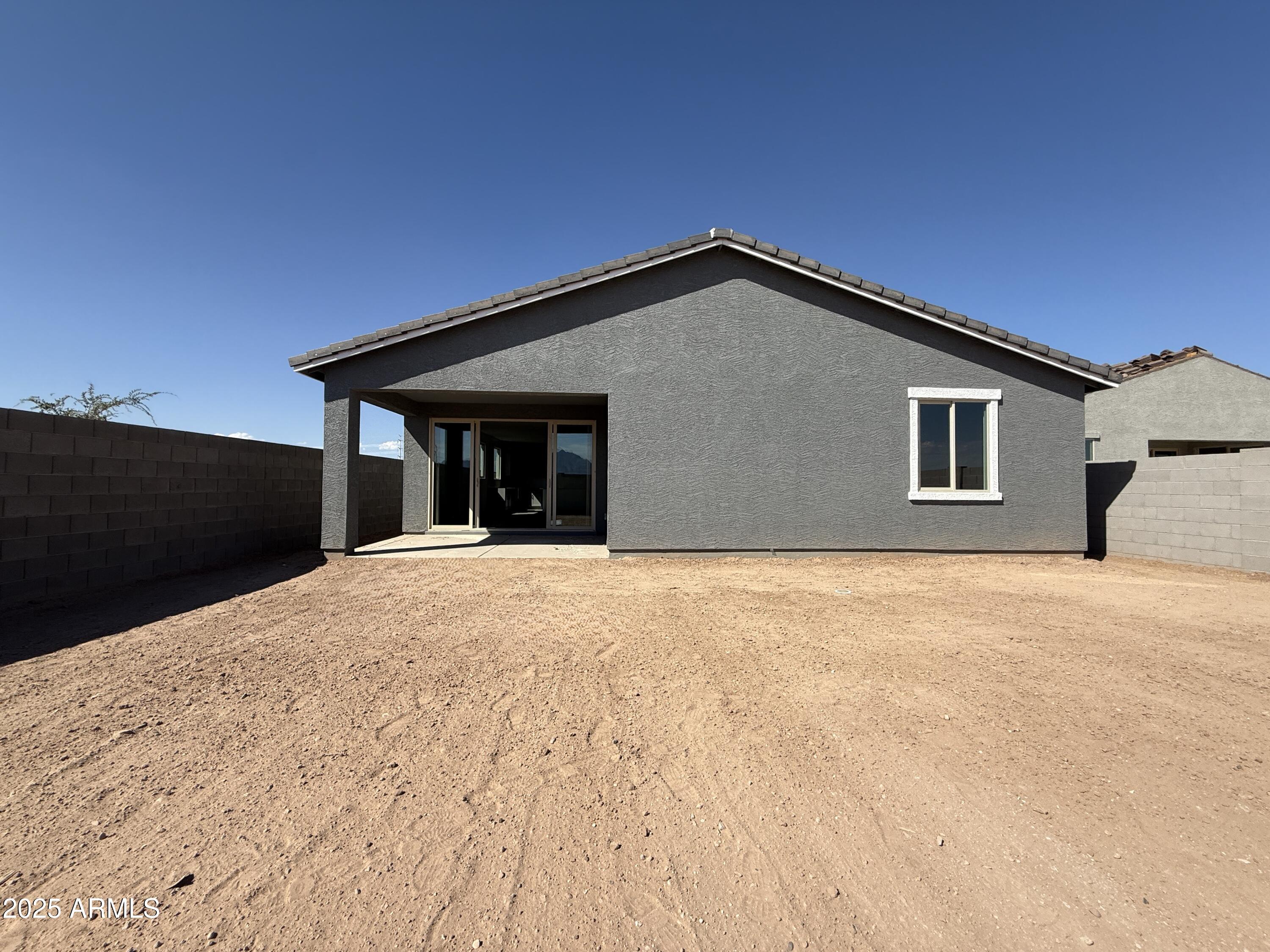 9627 West Tamarisk Avenue Tolleson, AZ 85353 - Photo 33 of 42 a front view of a house with a yard