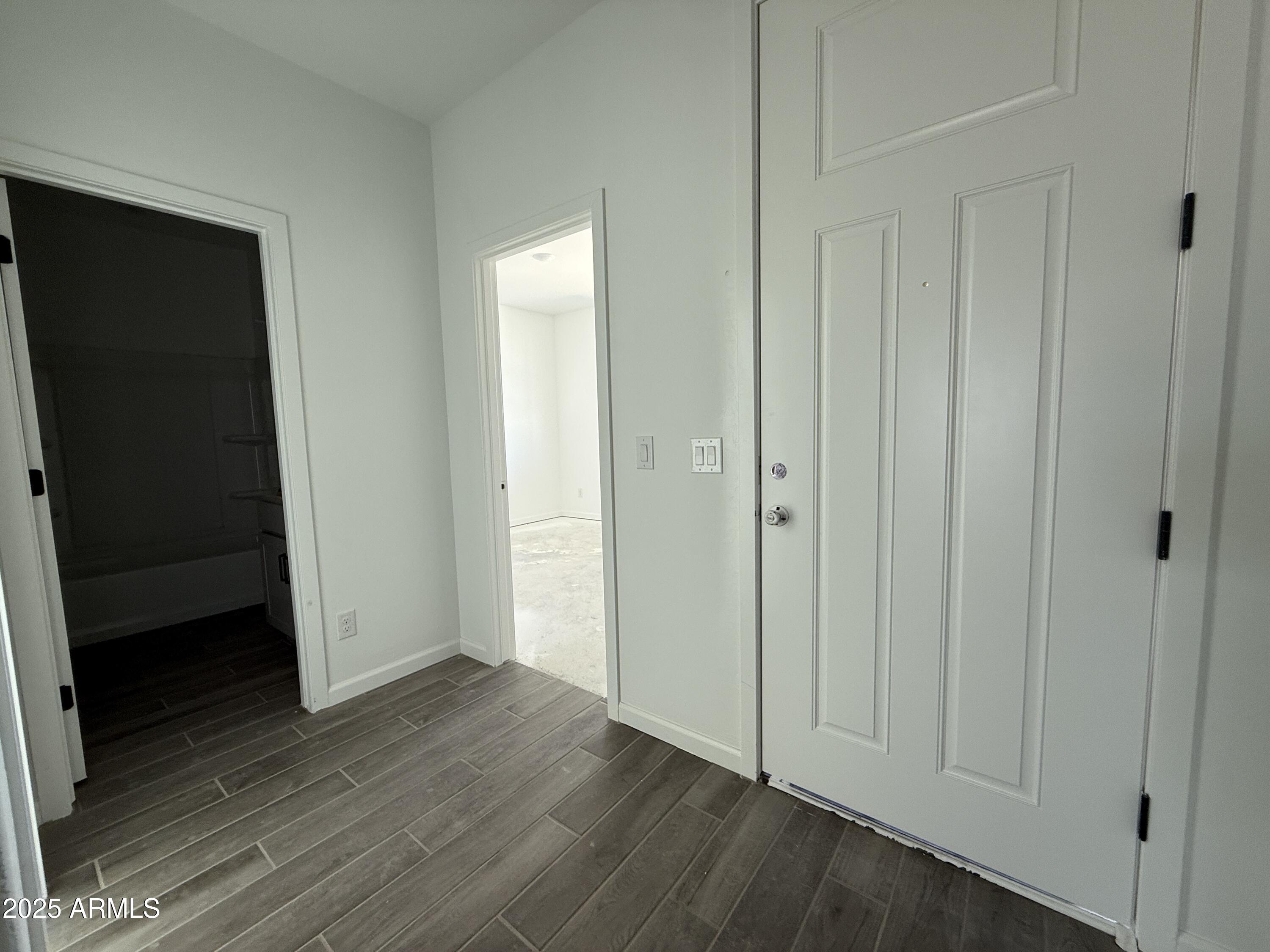 9627 West Tamarisk Avenue Tolleson, AZ 85353 - Photo 4 of 42 a view of an empty room with wooden floor and closet