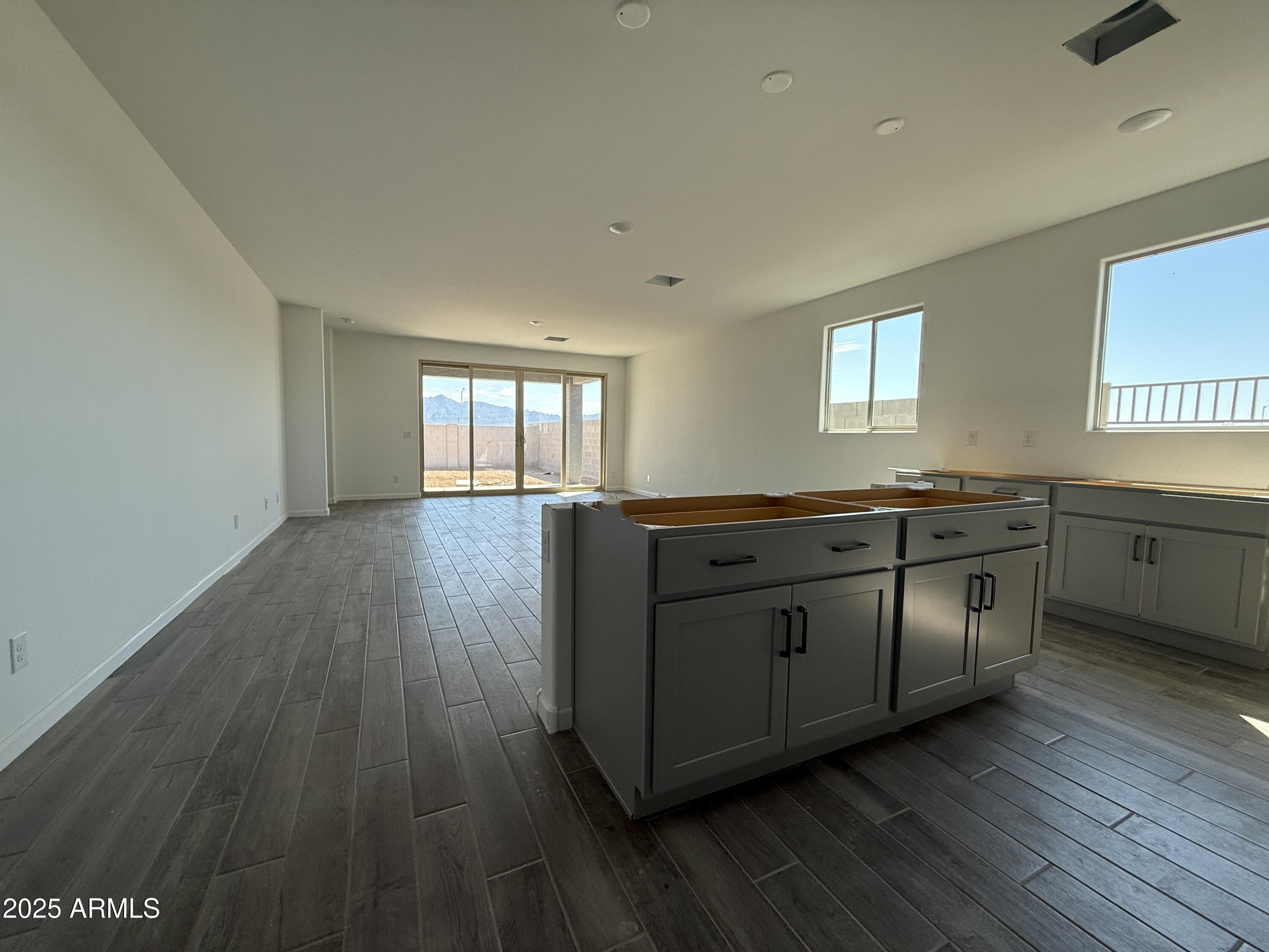 9627 West Tamarisk Avenue Tolleson, AZ 85353 - Photo 10 of 42 a kitchen with stainless steel appliances granite countertop a sink a stove and wooden floors