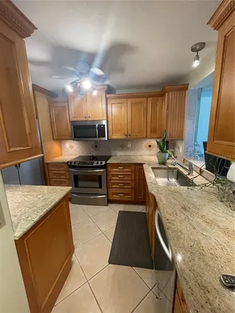 a kitchen with a stove a sink and a refrigerator