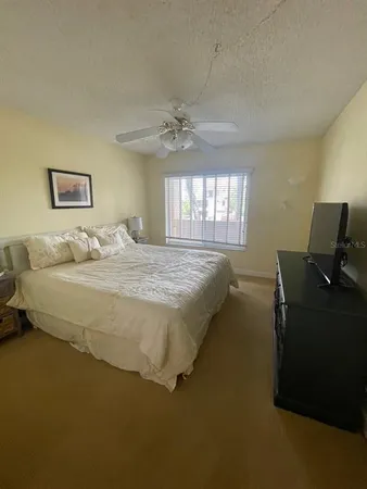 a bedroom with a bed dresser and a window