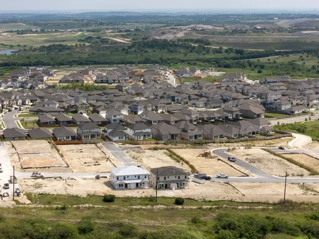 an aerial view of residential houses with outdoor space