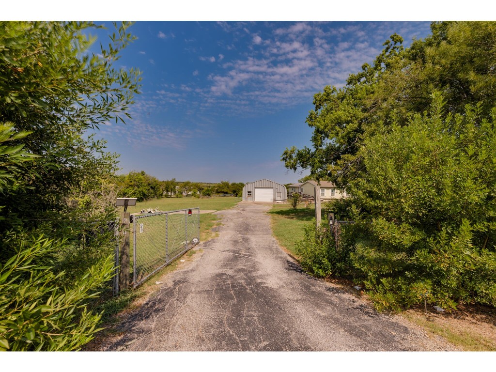 13506 Palmer Road Buda, TX 78610 - Photo 16 of 33 a view of a lake with outdoor space