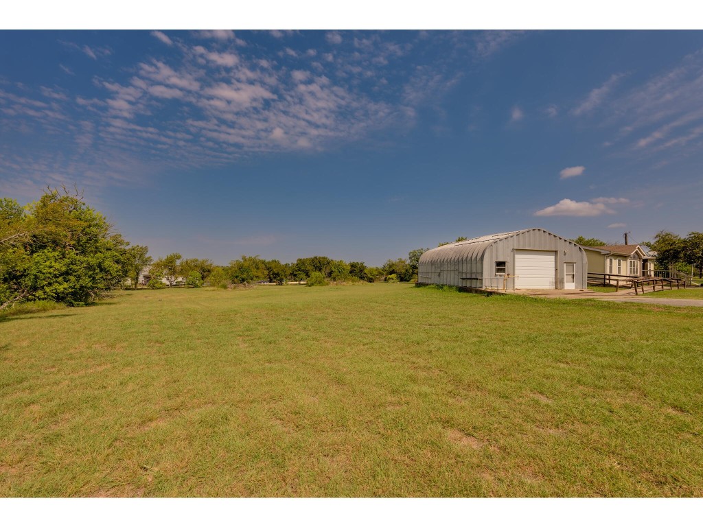 13506 Palmer Road Buda, TX 78610 - Photo 20 of 33 a house with a lake view