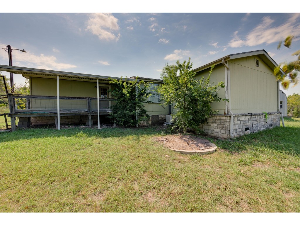 13506 Palmer Road Buda, TX 78610 - Photo 27 of 33 a backyard of a house with wooden fence and a bench