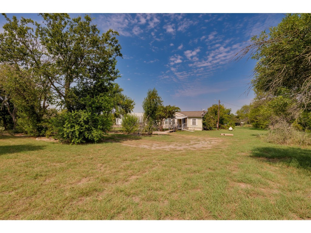 13506 Palmer Road Buda, TX 78610 - Photo 30 of 33 a view of a large yard with an outdoor space