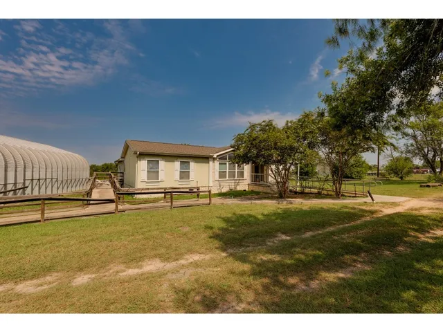 a swimming pool with some trees in the background