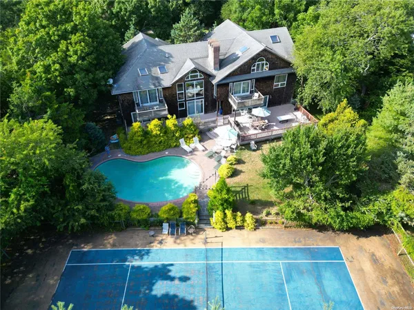 an aerial view of a house with yard swimming pool and outdoor seating
