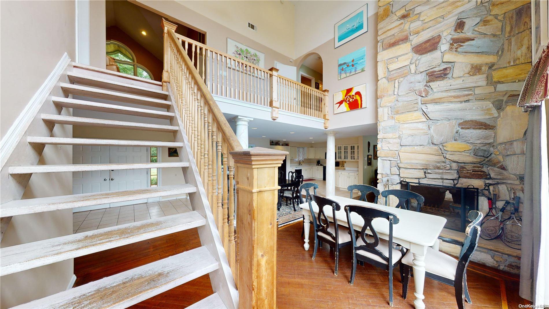 28 Club Lane Remsenburg, NY 11960 - Photo 11 of 33 a view of a livingroom with furniture and staircase