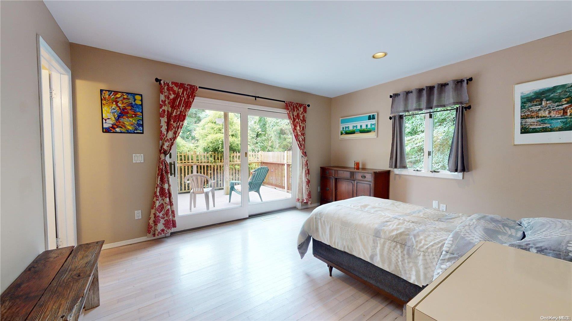 28 Club Lane Remsenburg, NY 11960 - Photo 13 of 33 a bedroom with a large bed and a large window
