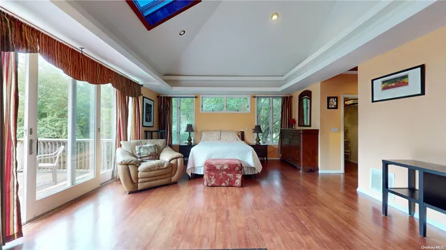 a spacious bedroom with a large bed and a large window