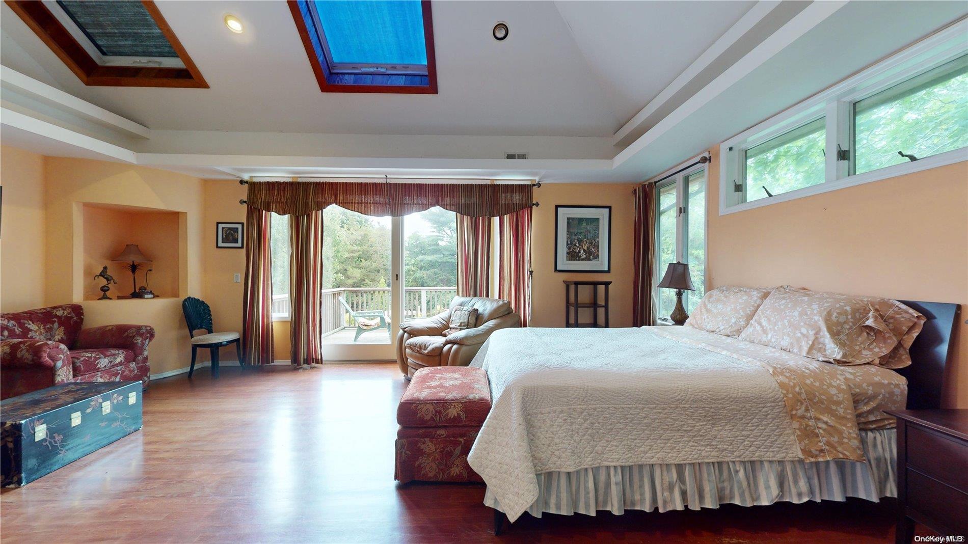 28 Club Lane Remsenburg, NY 11960 - Photo 15 of 33 a bedroom with a bed and a couch