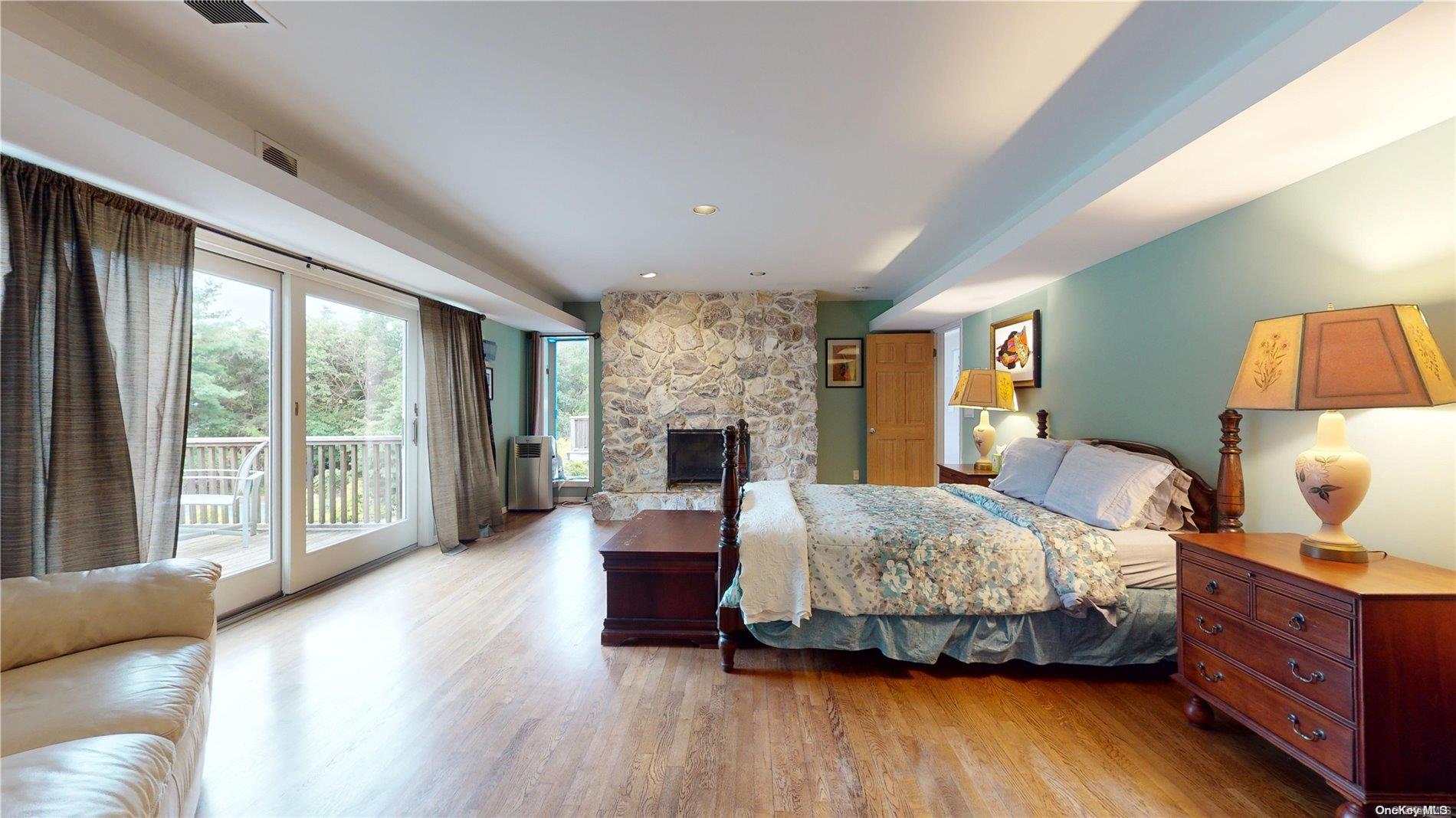 28 Club Lane Remsenburg, NY 11960 - Photo 17 of 33 a bedroom with a bed and large window