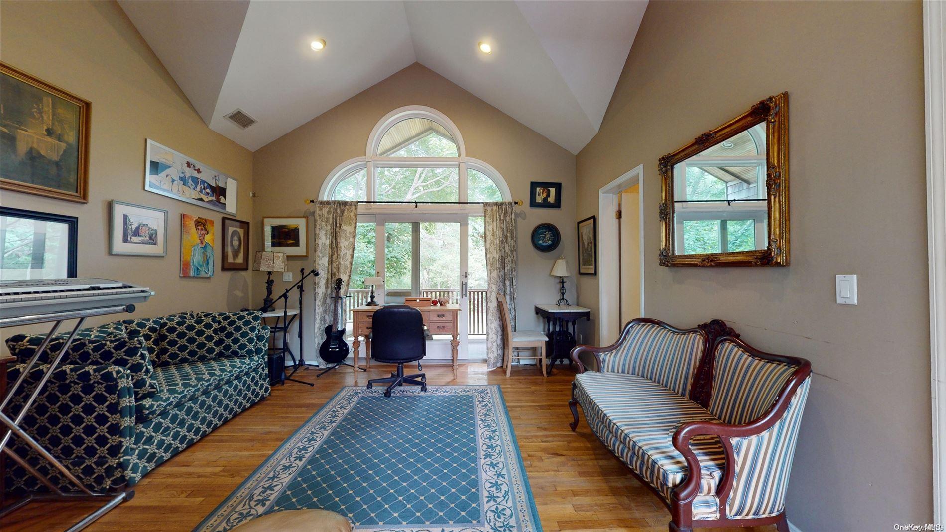 28 Club Lane Remsenburg, NY 11960 - Photo 19 of 33 a living room with furniture fireplace and a large window