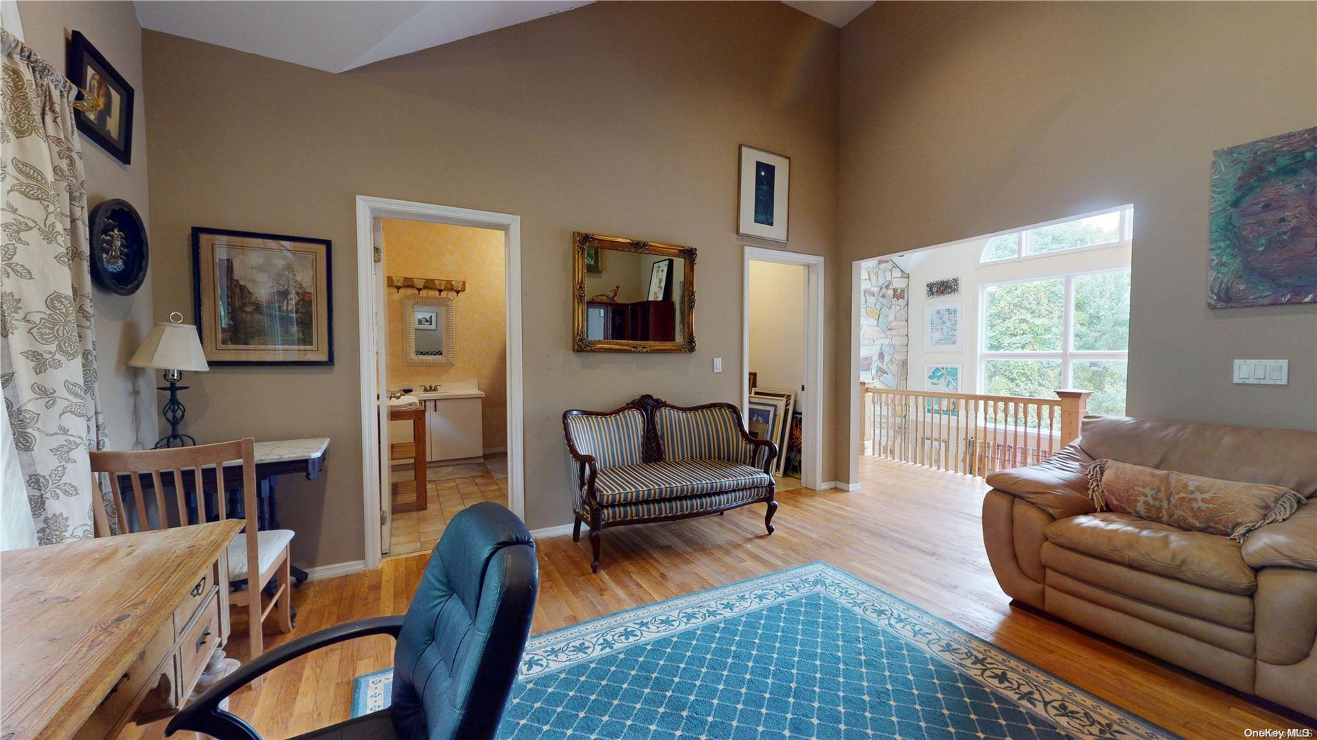 28 Club Lane Remsenburg, NY 11960 - Photo 20 of 33 a living room with furniture and a window