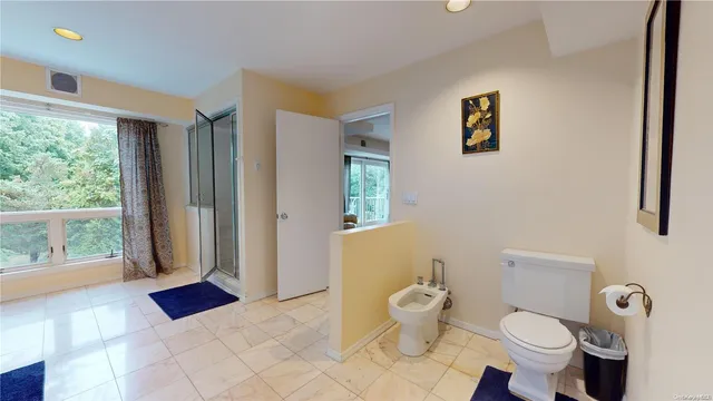 a bathroom with a toilet sink and mirror