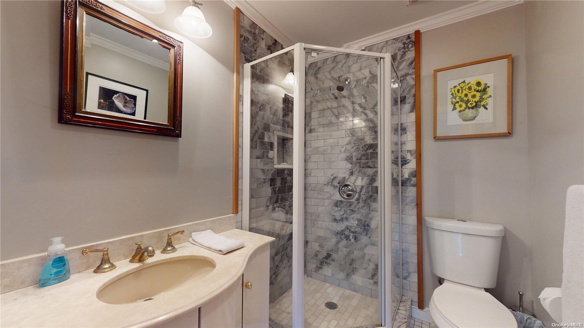 28 Club Lane Remsenburg, NY 11960 - Photo 26 of 33 a bathroom with a sink toilet and shower