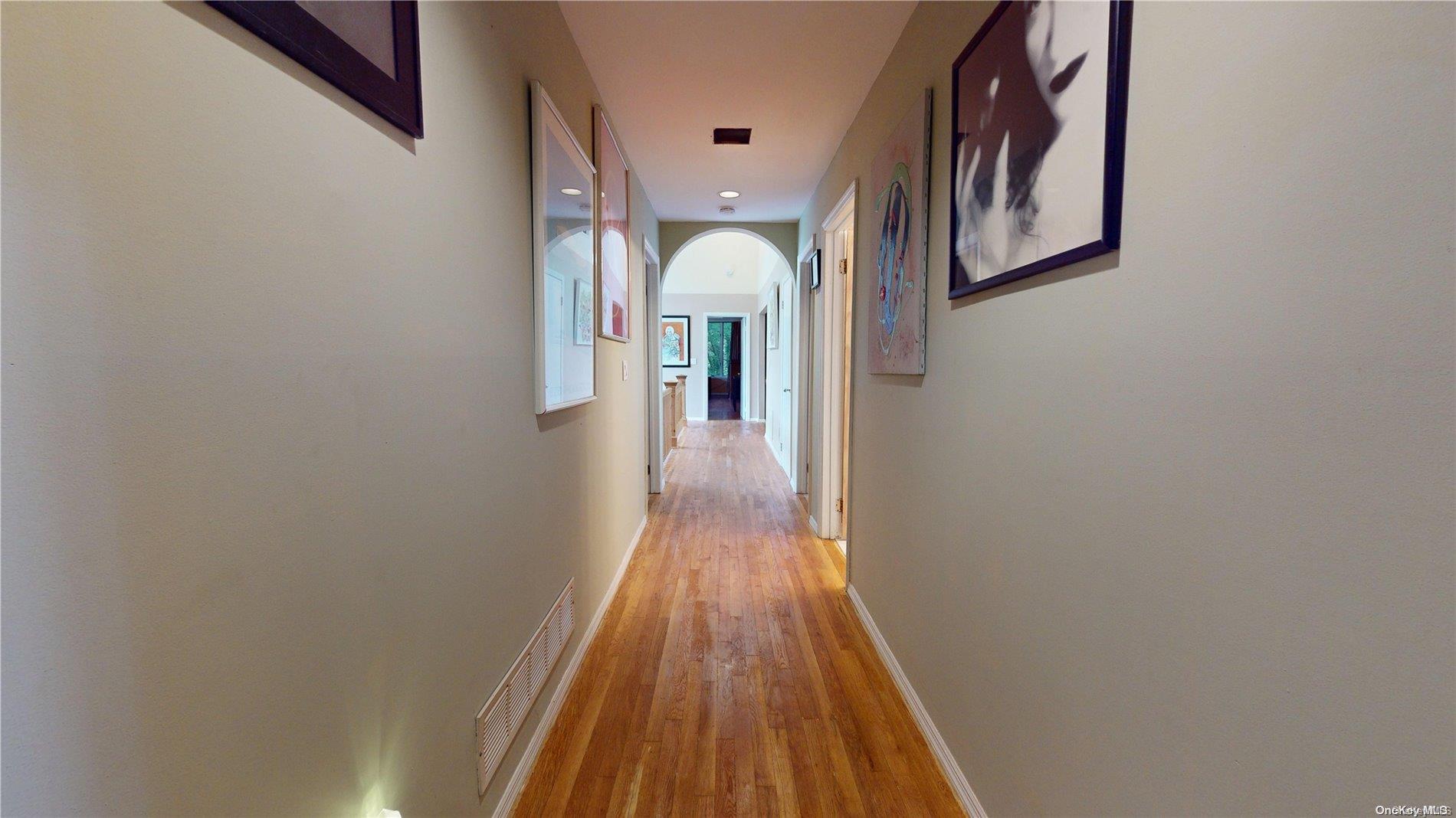 28 Club Lane Remsenburg, NY 11960 - Photo 28 of 33 a view of a hallway with wooden floor