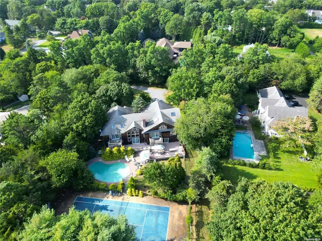 an aerial view of a house with a yard and lake view