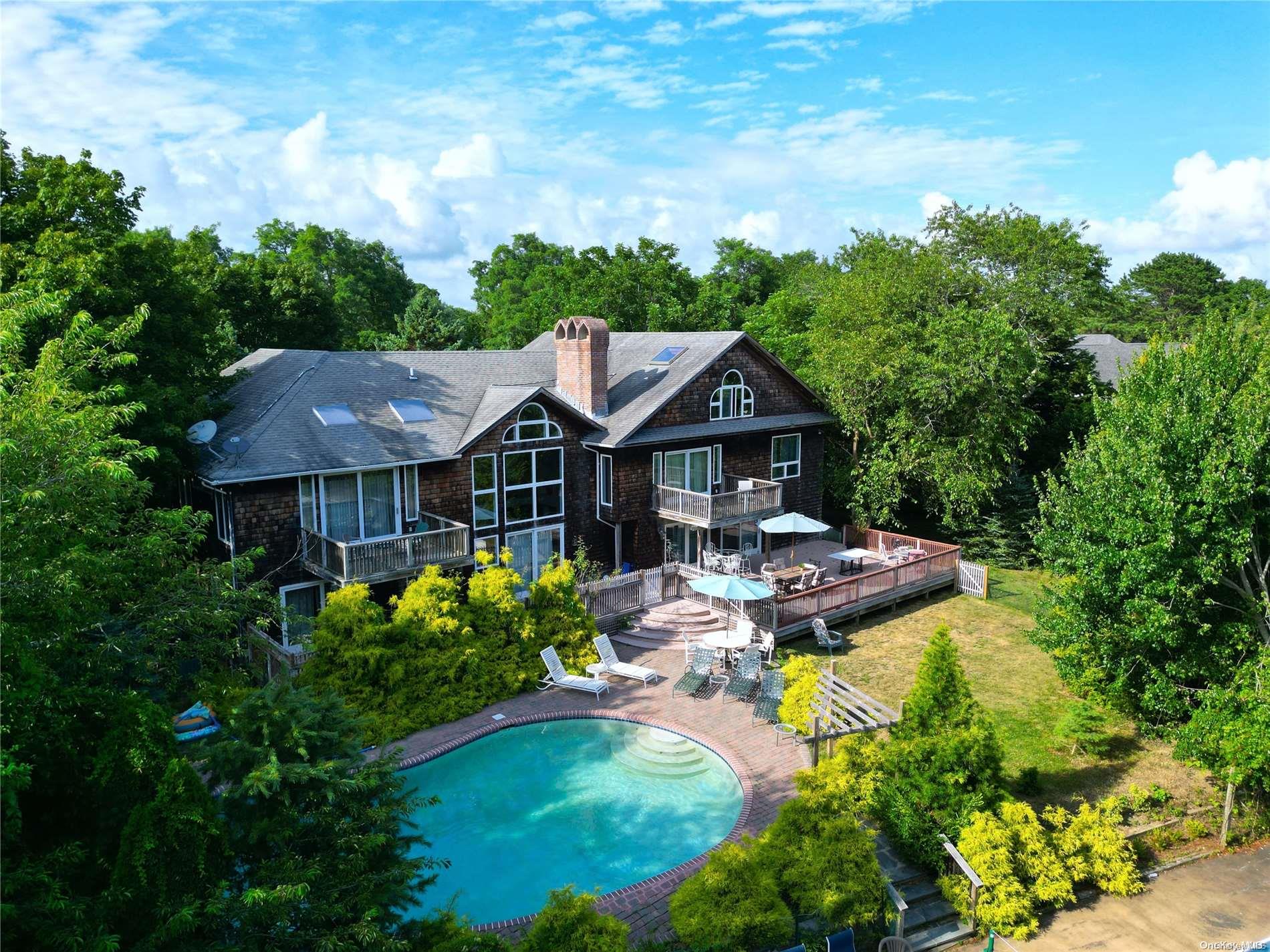 28 Club Lane Remsenburg, NY 11960 - Photo 32 of 33 a aerial view of a house with swimming pool garden view and lake view