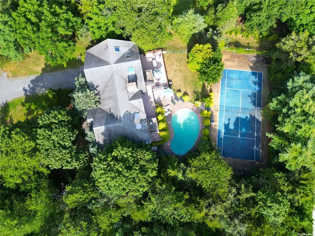 an aerial view of a house with a yard and garden