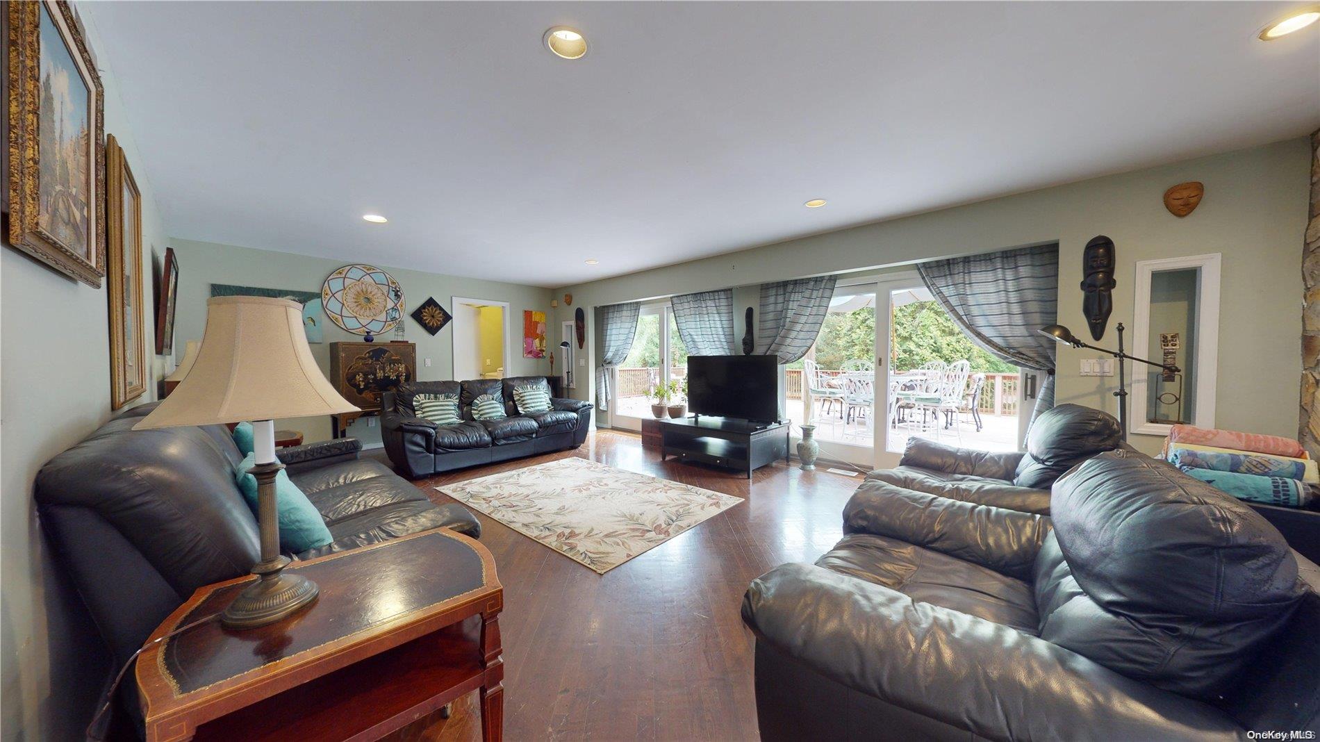 28 Club Lane Remsenburg, NY 11960 - Photo 10 of 33 a living room with furniture and a large window