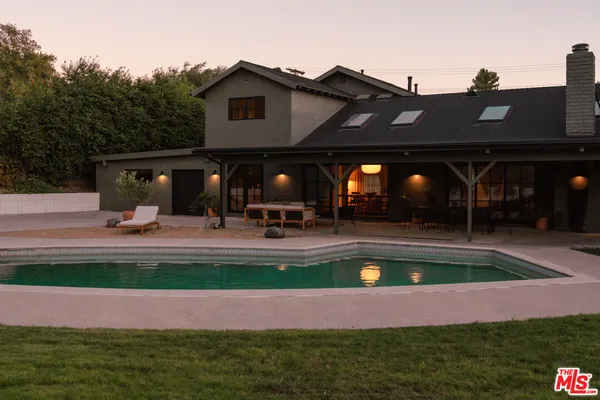 a view of swimming pool with outdoor seating