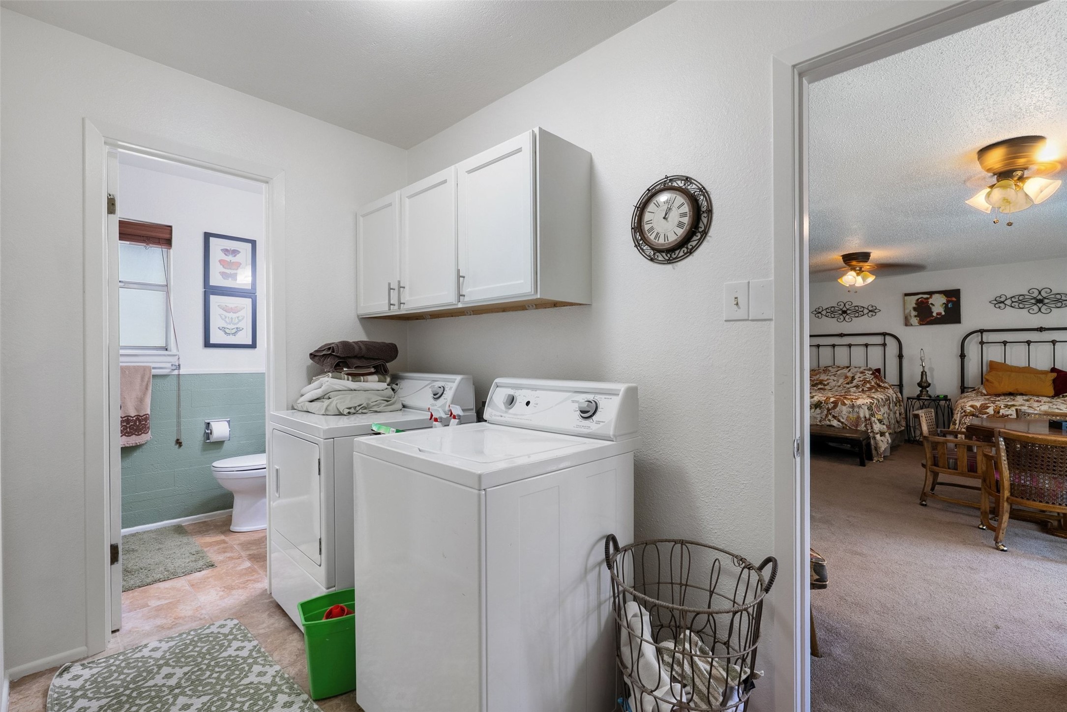 141 Perry Lane Kingsland, TX 78639 - Photo 33 of 40 Functional laundry room featuring a washer and dryer, complemented by overhead cabinetry.