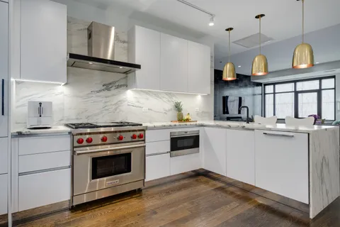 a kitchen with a stove oven and a sink