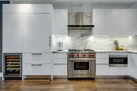 a kitchen with stainless steel appliances a stove and a refrigerator