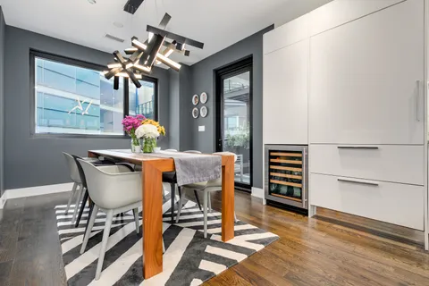 a dining room with furniture and wooden floor