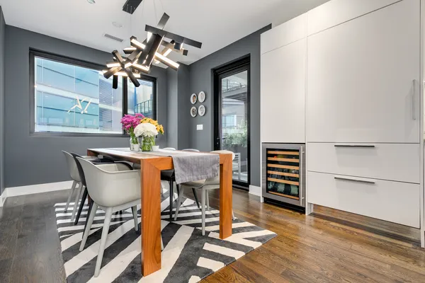 a dining room with furniture and wooden floor