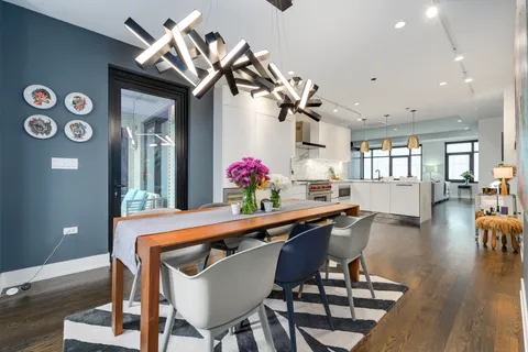 a dining room with furniture and wooden floor
