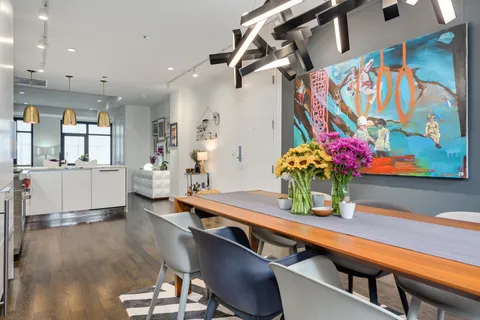 a living room with furniture and flowers