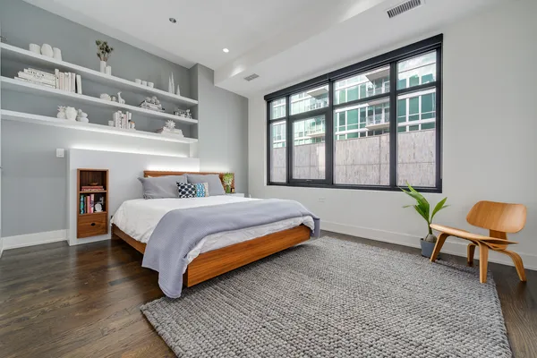 a bedroom with a bed and a window