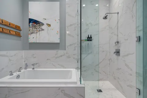 a bathroom with a bathtub and a shower