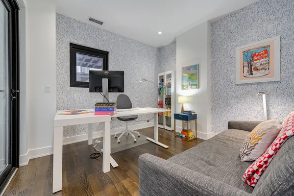 a living room with furniture and a wooden floor