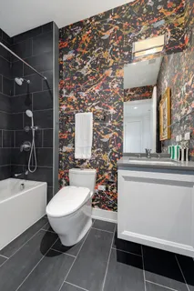 a bathroom with a toilet sink and mirror