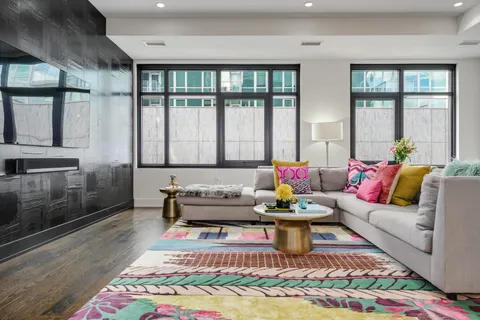 a living room with furniture and a floor to ceiling window