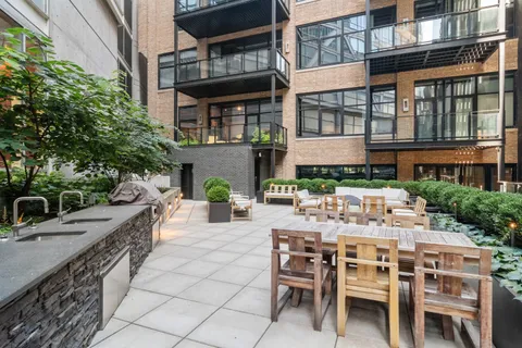 a view of a patio with a table and chairs