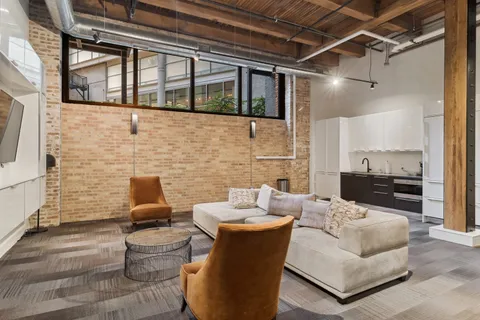 a living room with patio furniture and a fireplace